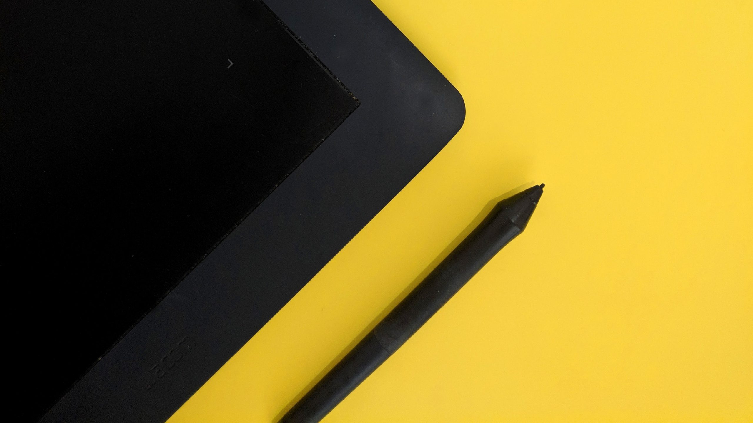 ipad black stylus in yellow background