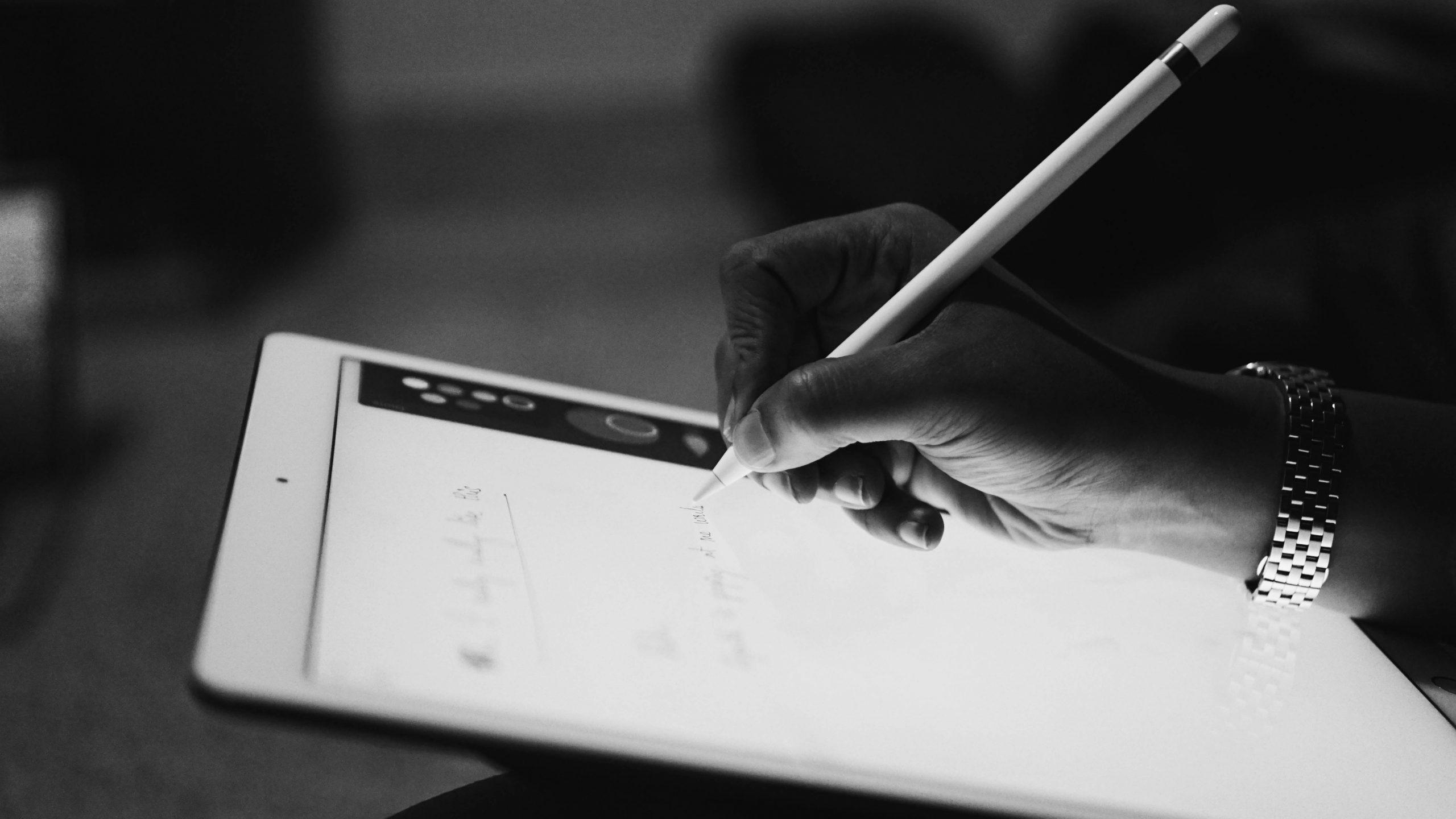 a person taking notes with an ipad and ipad pen